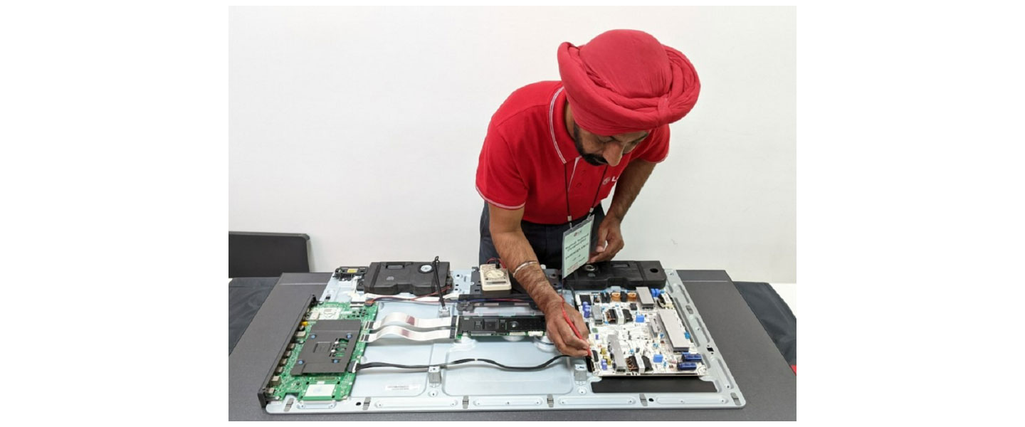 A photo of a LG Service Manager trying to fix a product