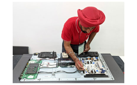 A photo of a LG Service Manager trying to fix a product