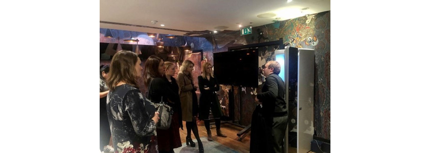 A male employee demonstrates the functions of LG Styler to visitors of LG UK's Styler launch event