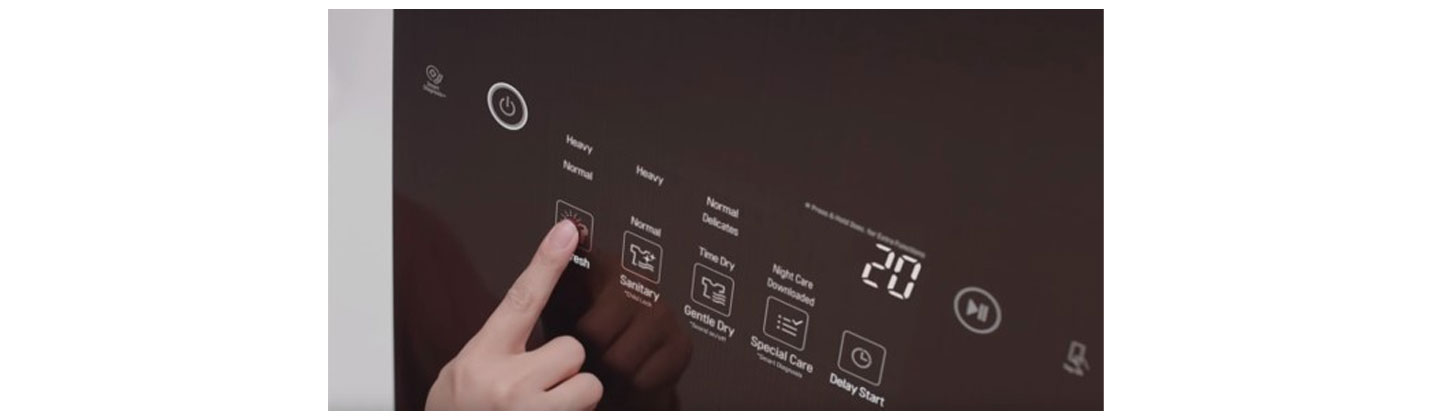 A close-up of someone pushing the Refresh button on the LG Styler’s display panel to eliminate germs and bacteria from their clothes
