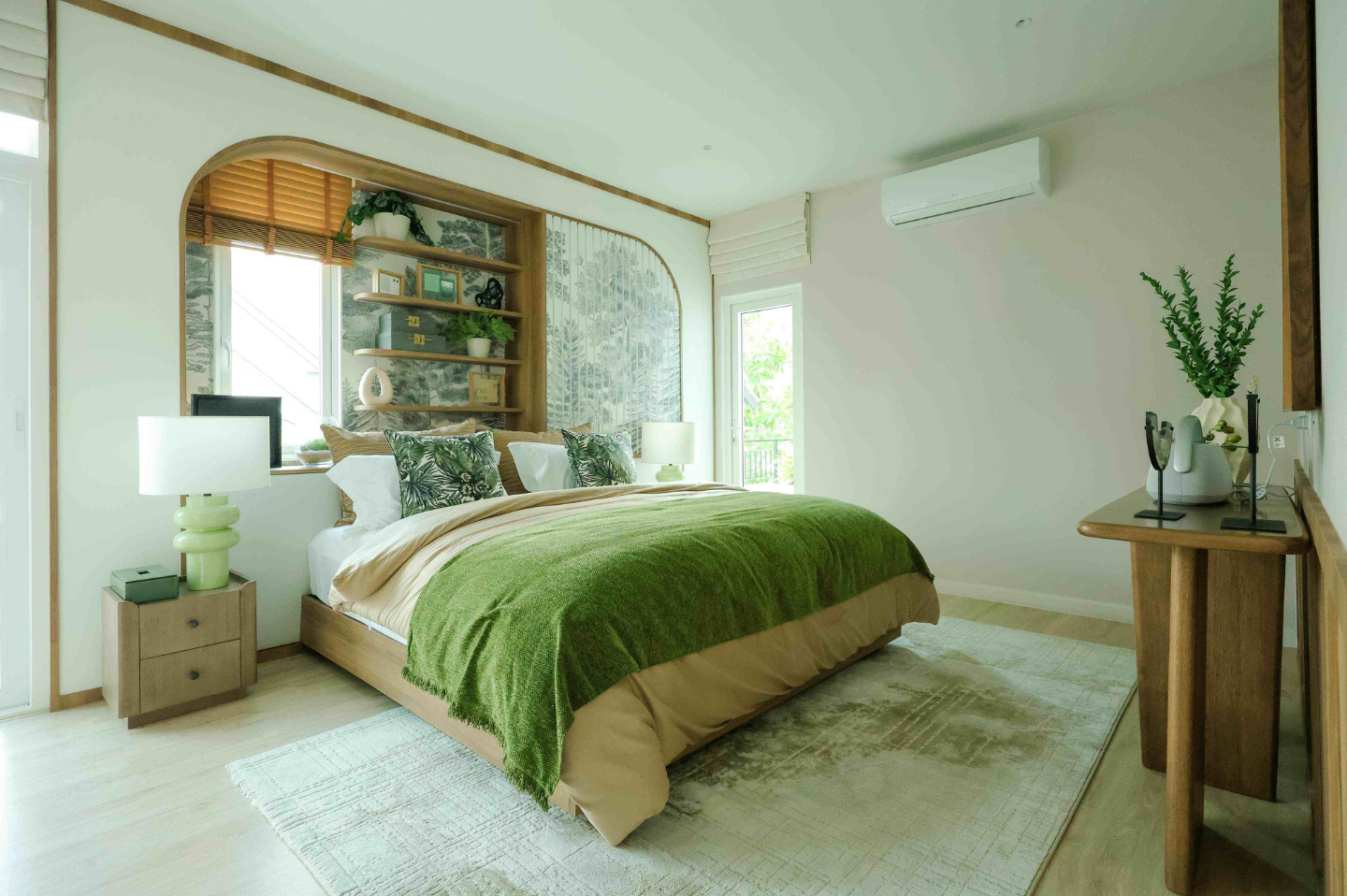 An LG Inverter air conditioner is attached to the wall of a calm bedroom decorated in green and white.