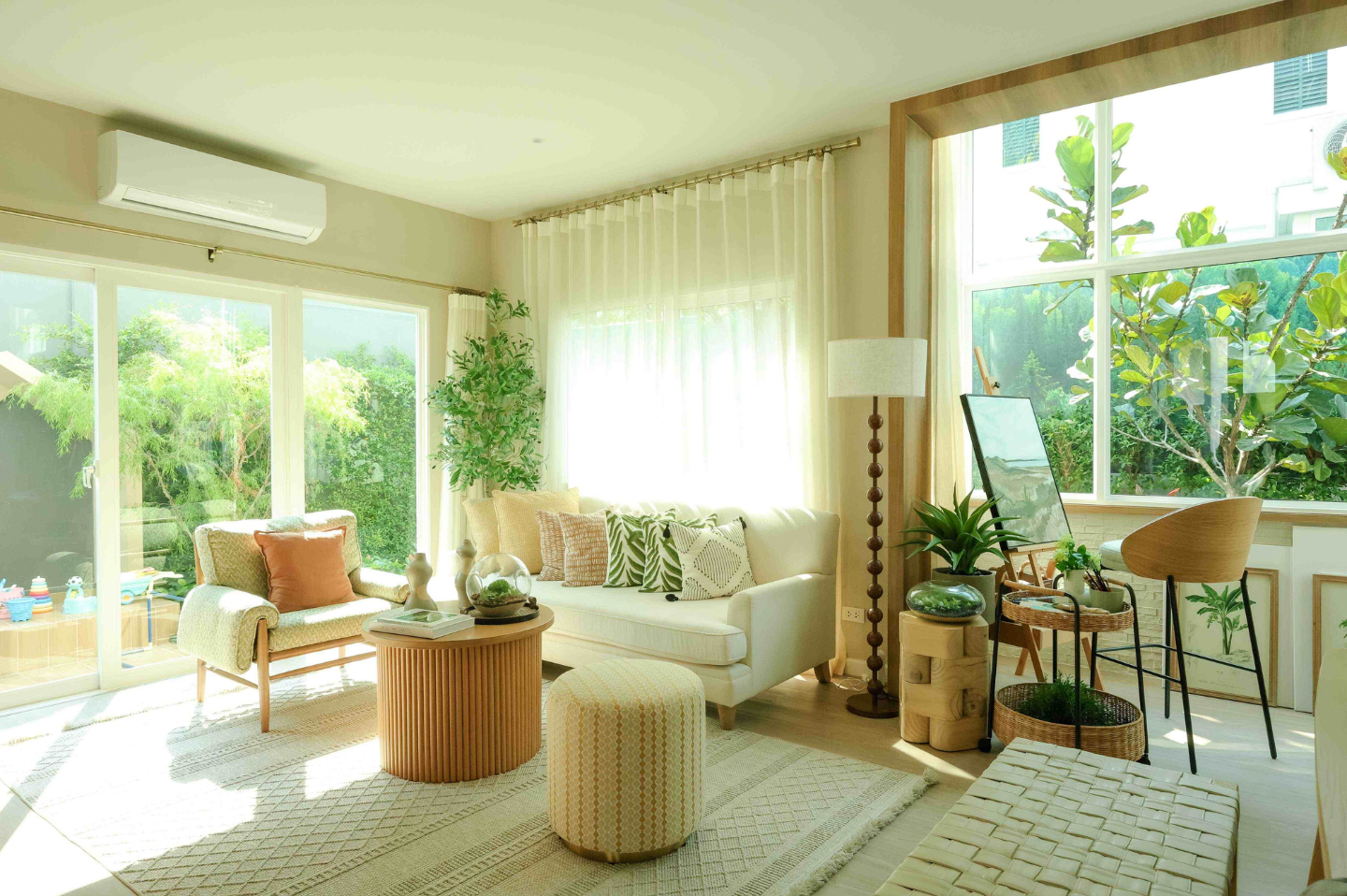 An LG Inverter air conditioner is attached to the wall above a patio door in a sunlit living space.