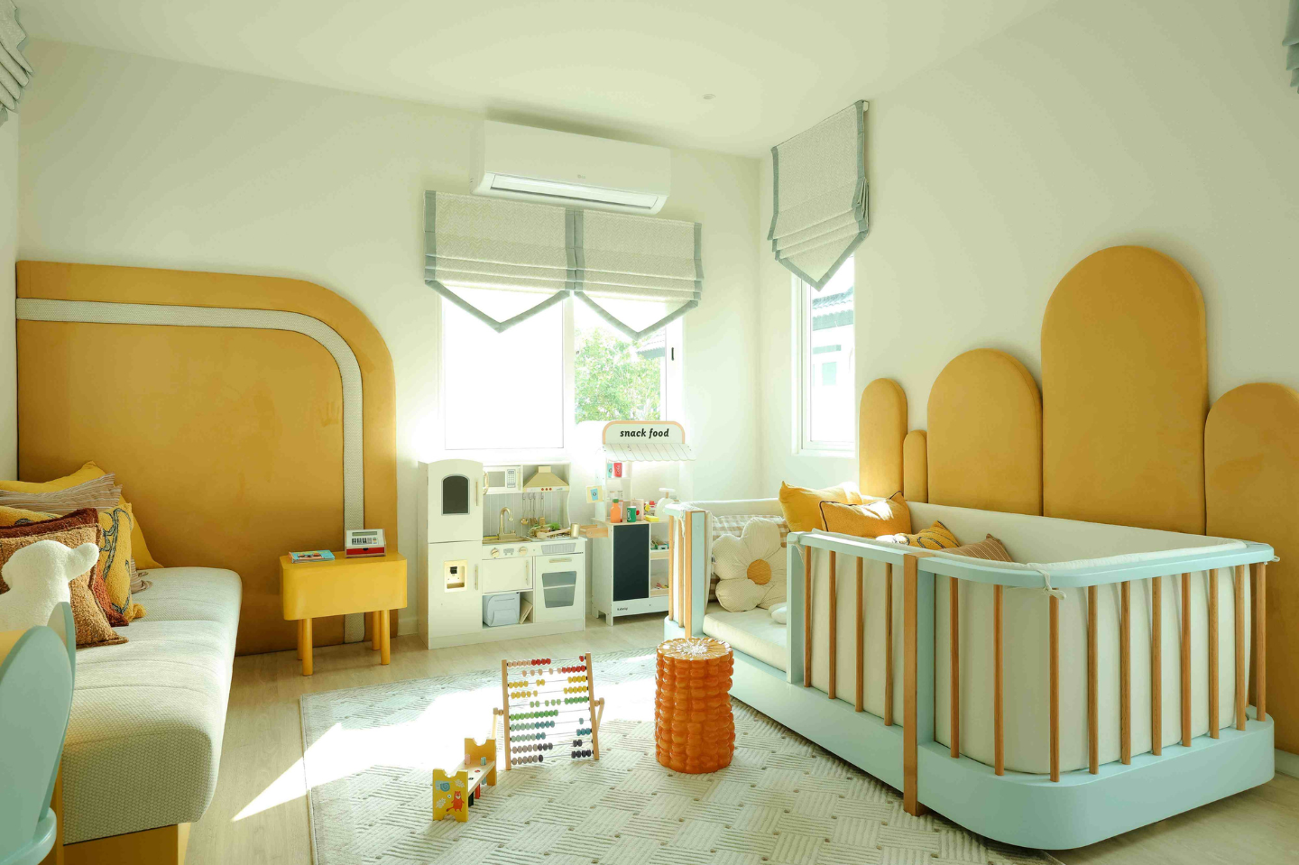 An LG Inverter air conditioner is attached the wall above a window in a child's bedroom.
