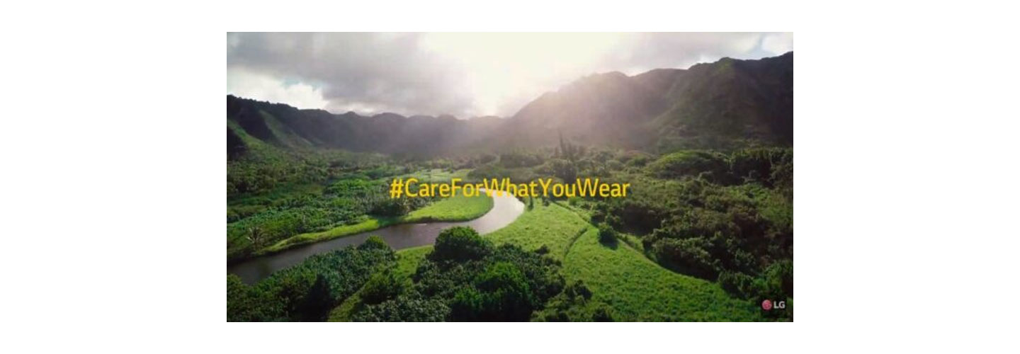 An image for LG's campaign, #CareForWhatYouWear for sustainable lifestyle, which displays a beautiful green landscape with trees, grass, and a river running through the middle