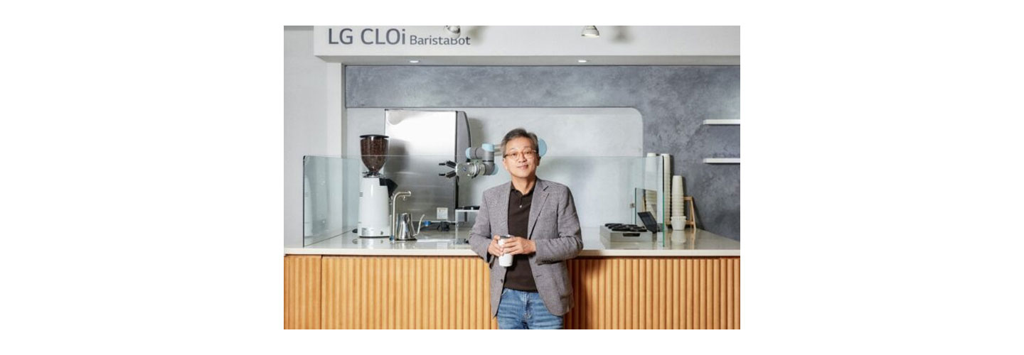 Lee Sam-soo, Chief Digital Officer at LG Electronics, posing in front of LG CLOi BaristaBot