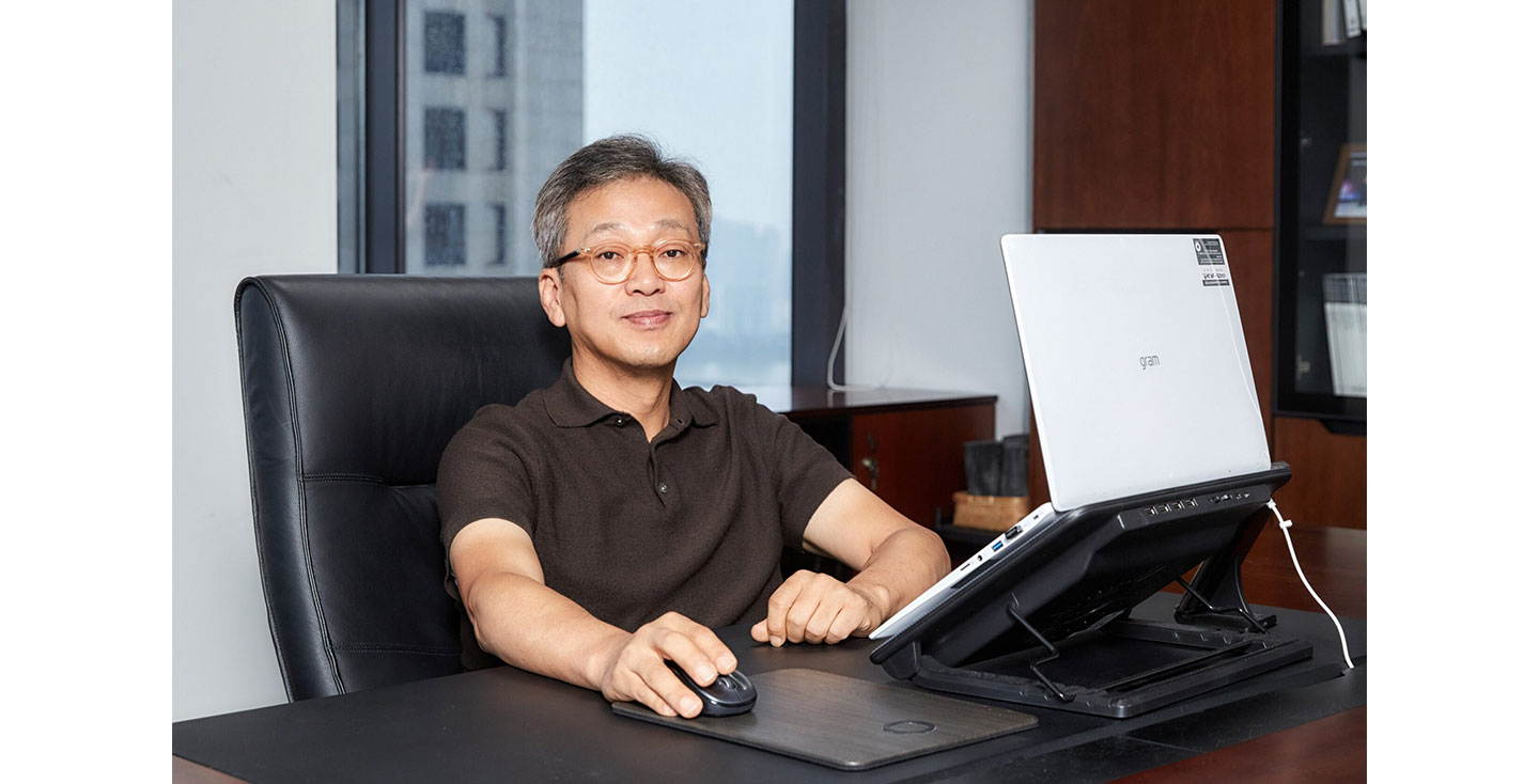 Lee Sam-soo, Chief Digital Officer at LG Electronics, posing at his office with LG gram