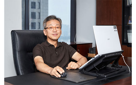 Lee Sam-soo, Chief Digital Officer at LG Electronics, posing at his office with LG gram