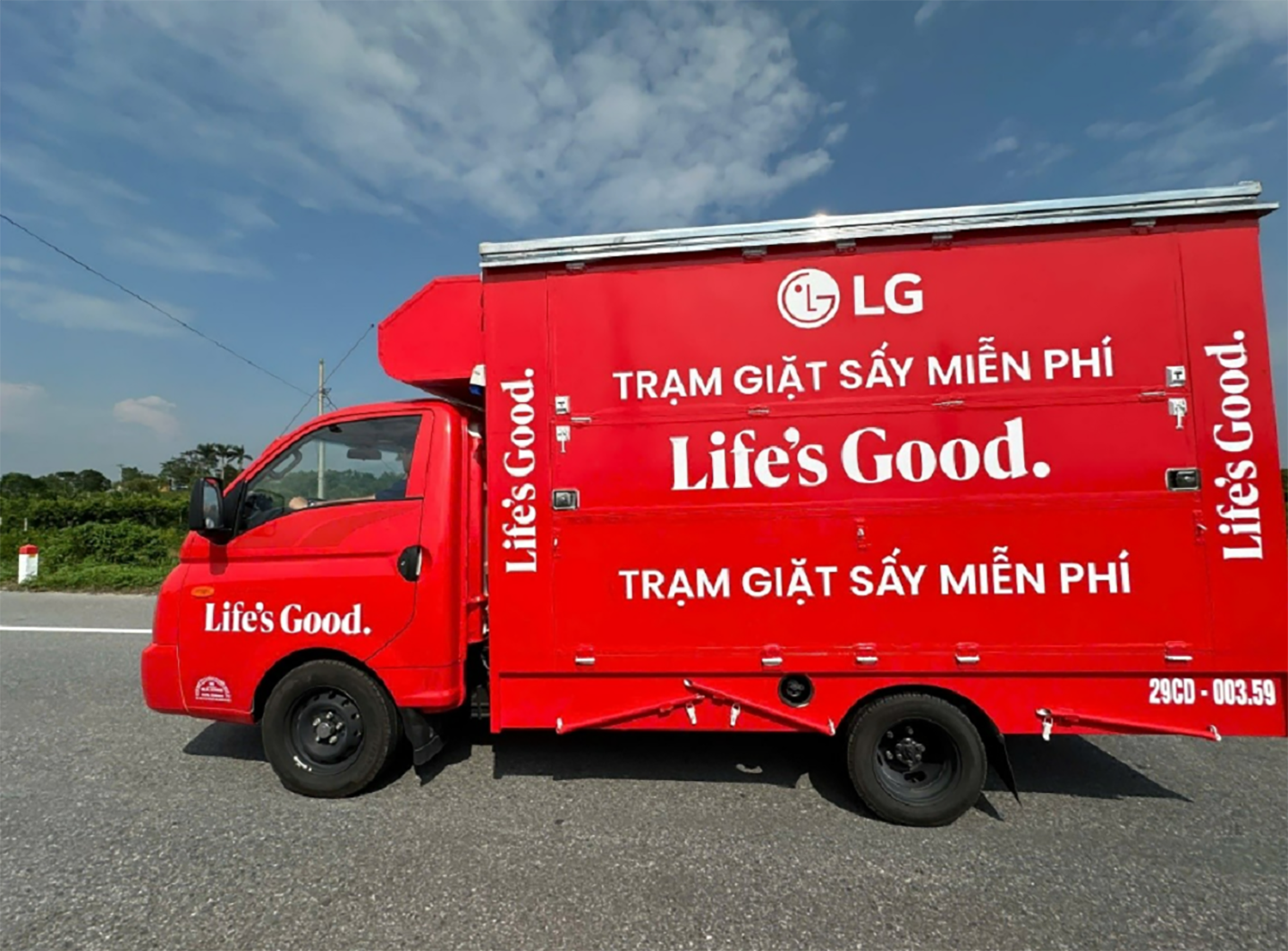 A photo of a red truck with the LG logo and 'Life's Good' on it