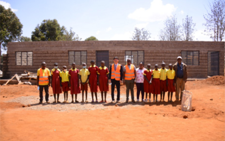 LG Electronics East Africa Managing Director Kim Sa-nyoung with HFH managers and students at the Mbombo Primary School construction site