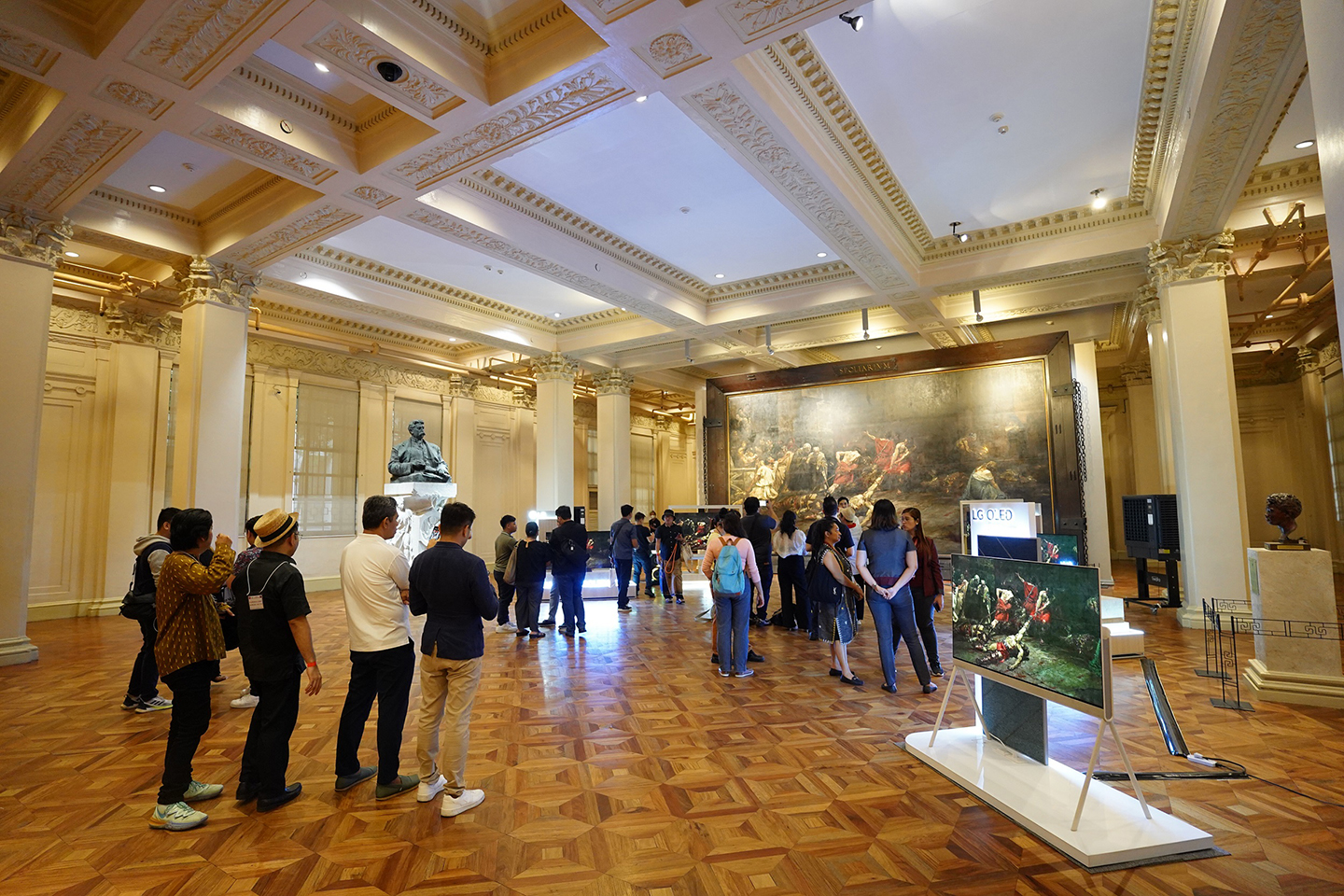 A photo of crowded visitors checking out the LG OLED TVs on display at the gallery 