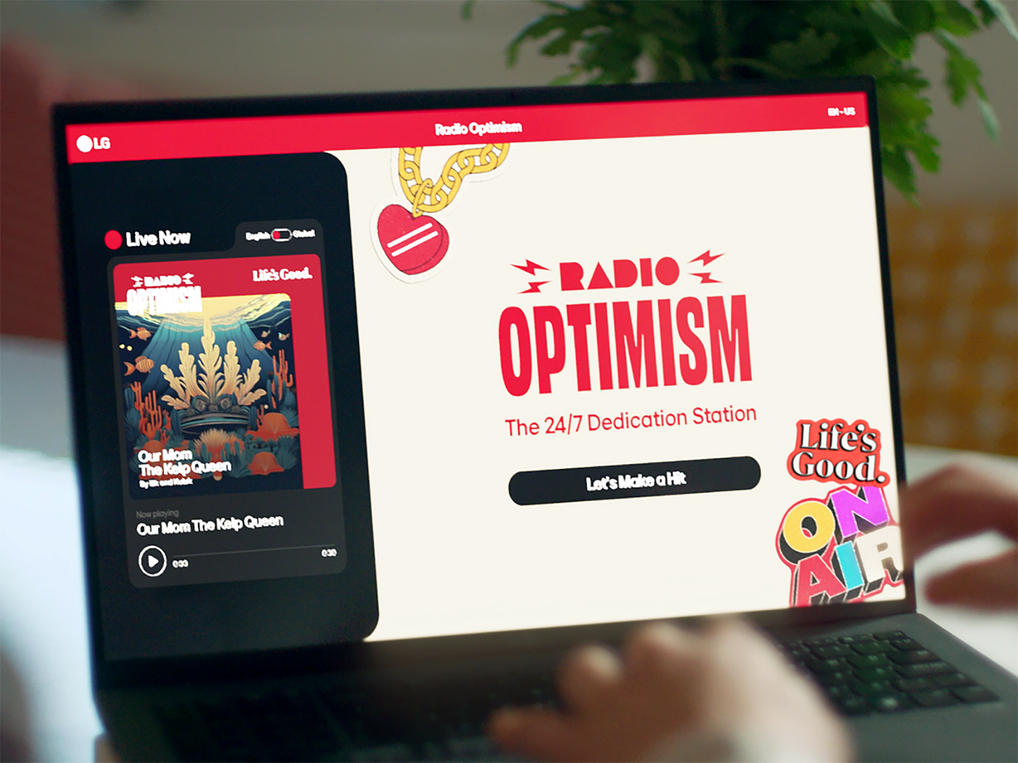 A photo of a laptop displaying the slogan 'Radio Optimism'