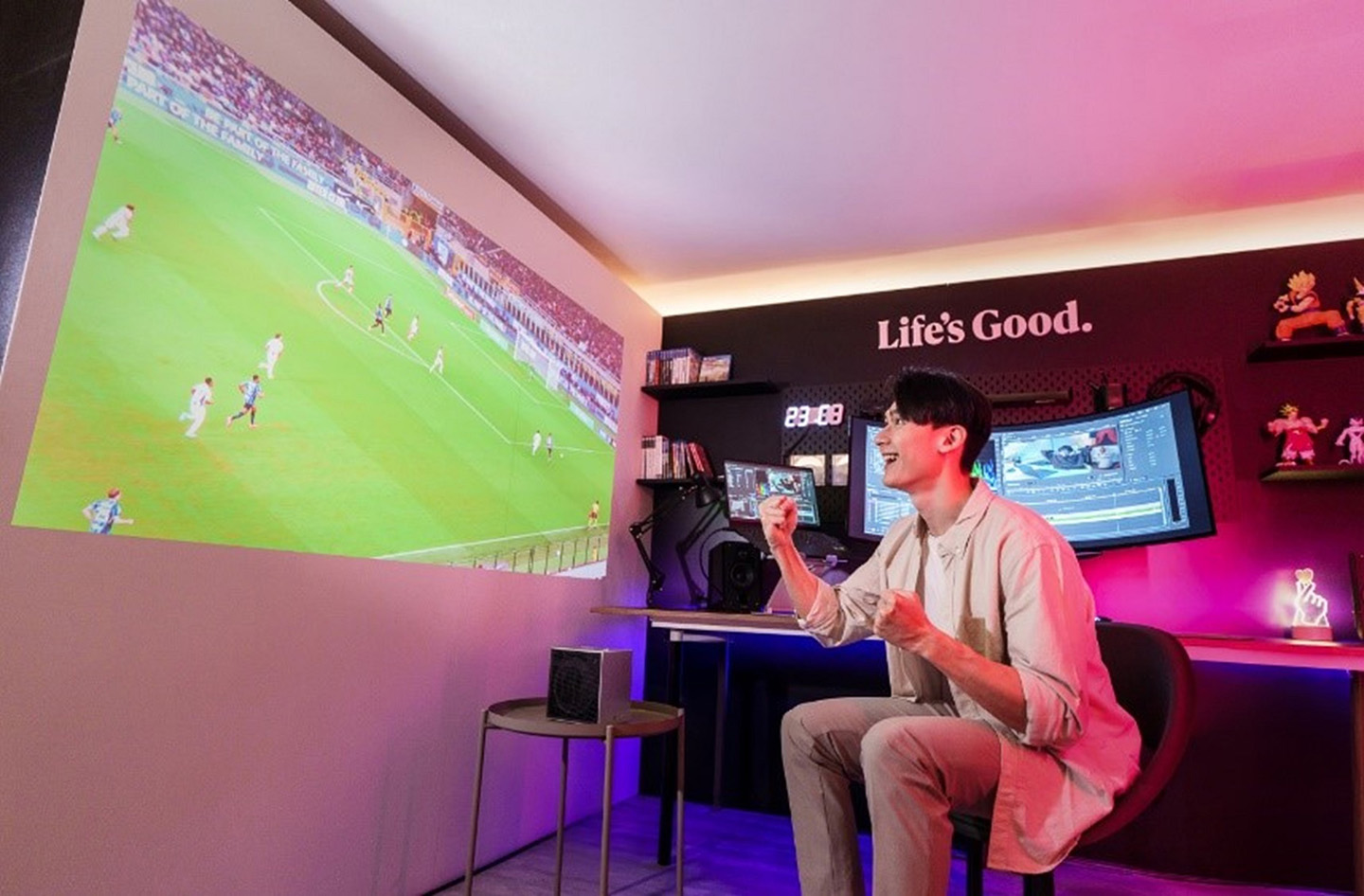 A photo of a man watching a football match via projector
