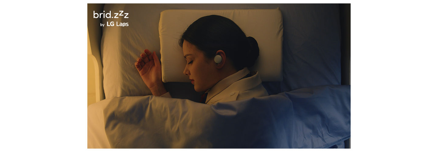 A photo of a woman using the brid.zzz wireless earbuds during her sleep