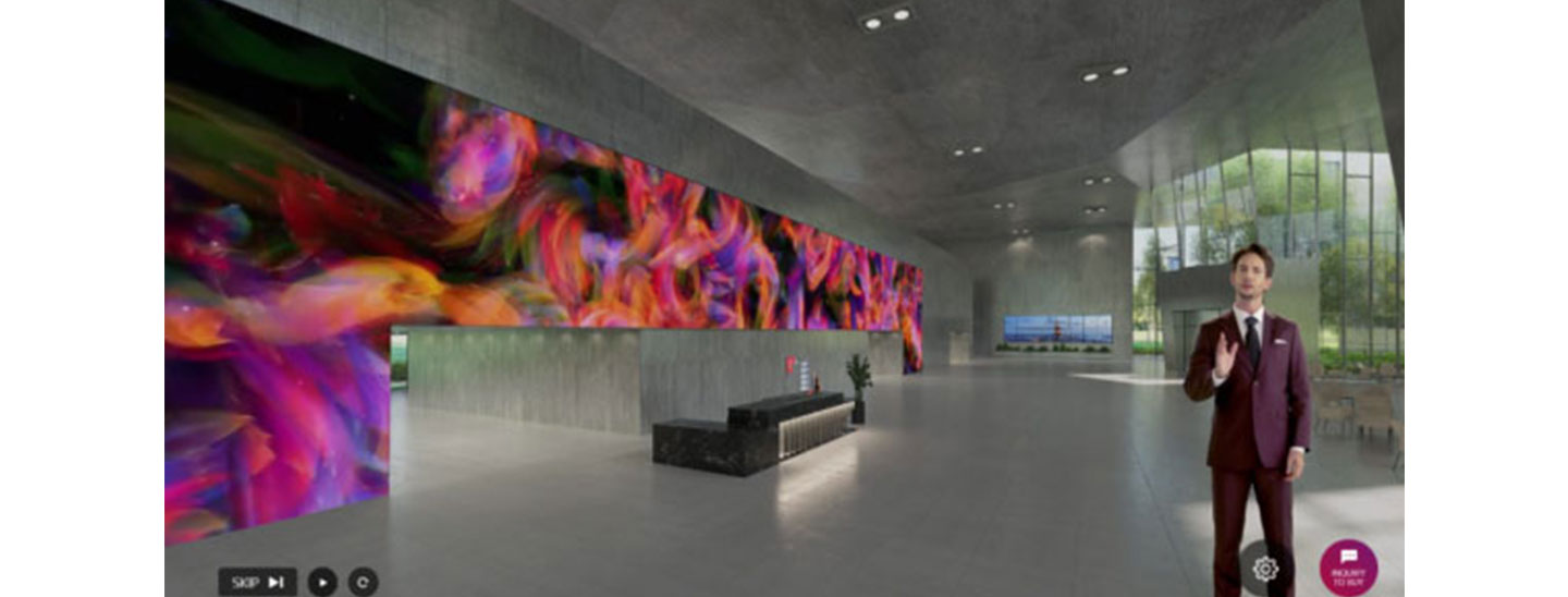 A presenter explains LG’s signage technologies in a building lobby setting during the Vertical Showroom Tour