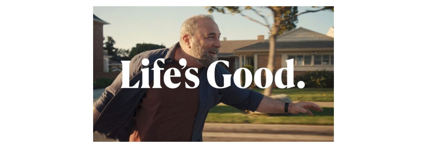 An image of a man riding a longboard with a phrase Life's Good overlapping