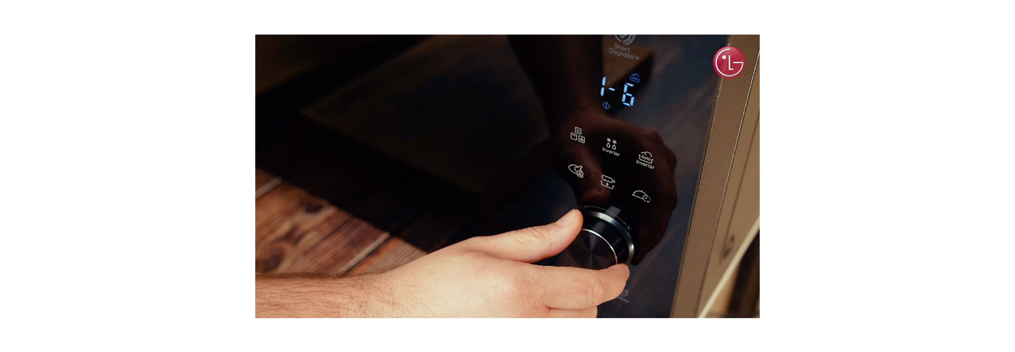 A close-up of Chef Marques using the LG NeoChef microwave oven’s user interface 