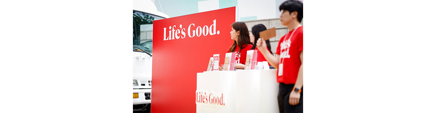 Staff standing behind the desk prepared for the Life's Good event