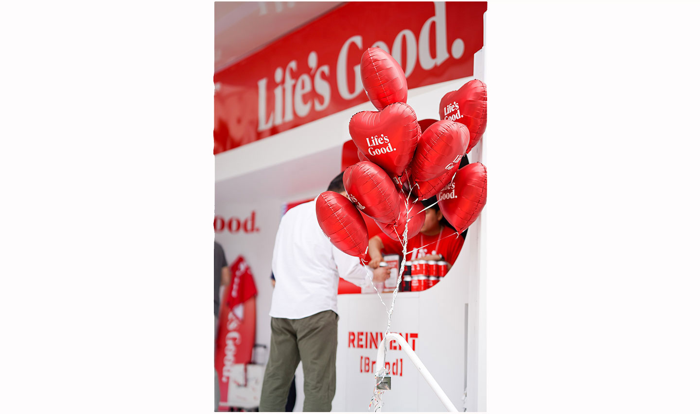 A close-up photo of a bunch of red balloons with the phrase 