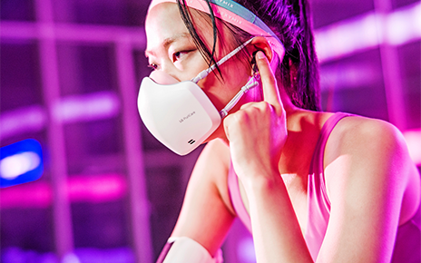 	 A woman wearing the newest LG PuriCare Wearable during a workout