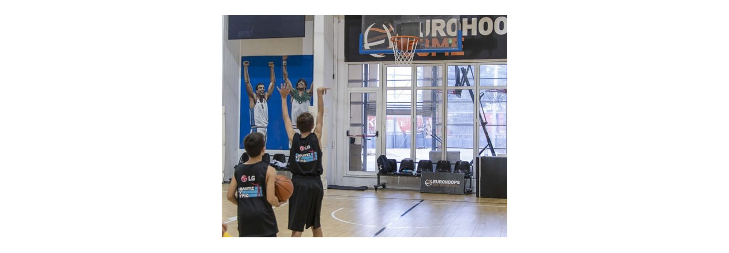 Children shooting the basketball during the LG Athletes of Tomorrow program