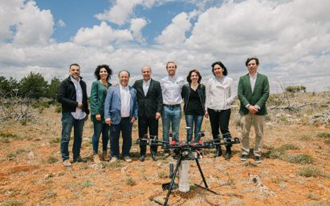 The associates of LG Smart Green project stand together behind the drone which is equipped with the LG G8S ThinQ smartphone.