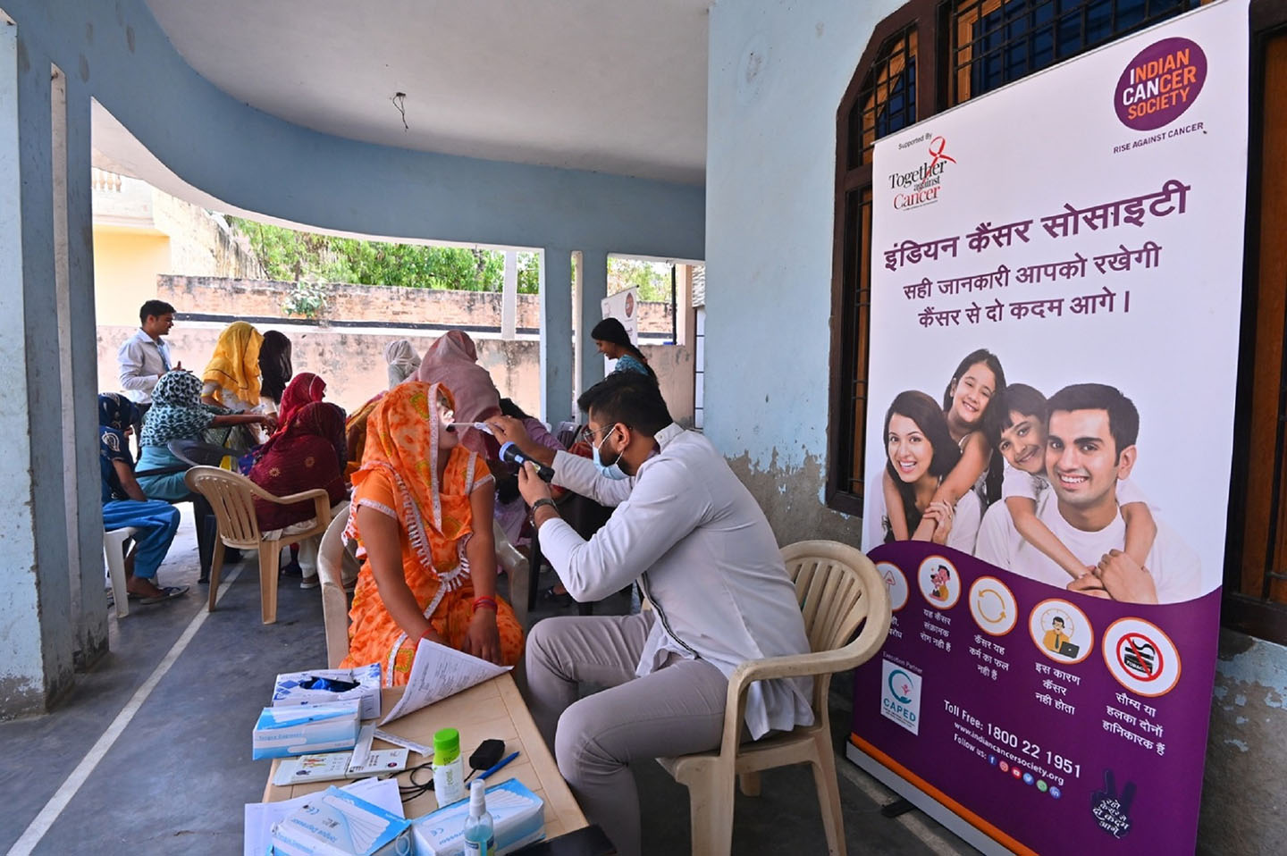 A picture of people getting their throat checked at the program area
