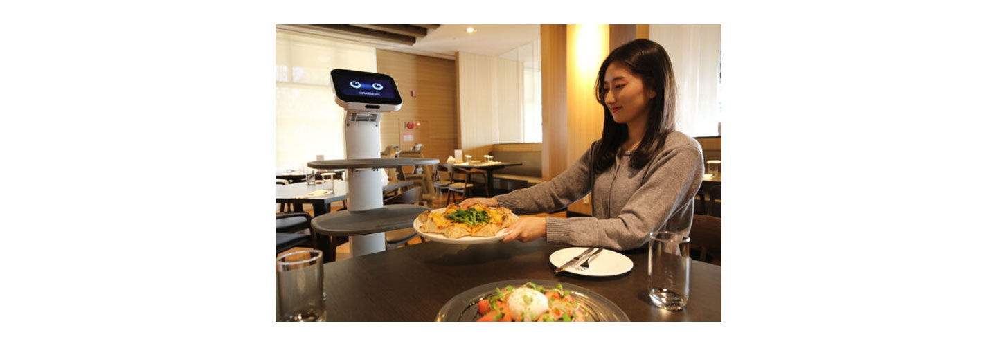 A person being served by LG ChefBot at a restaurant