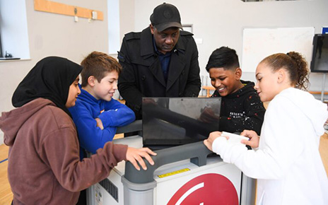 Students taking a closer look at LG gram with former English professional football player Emile Heskey.