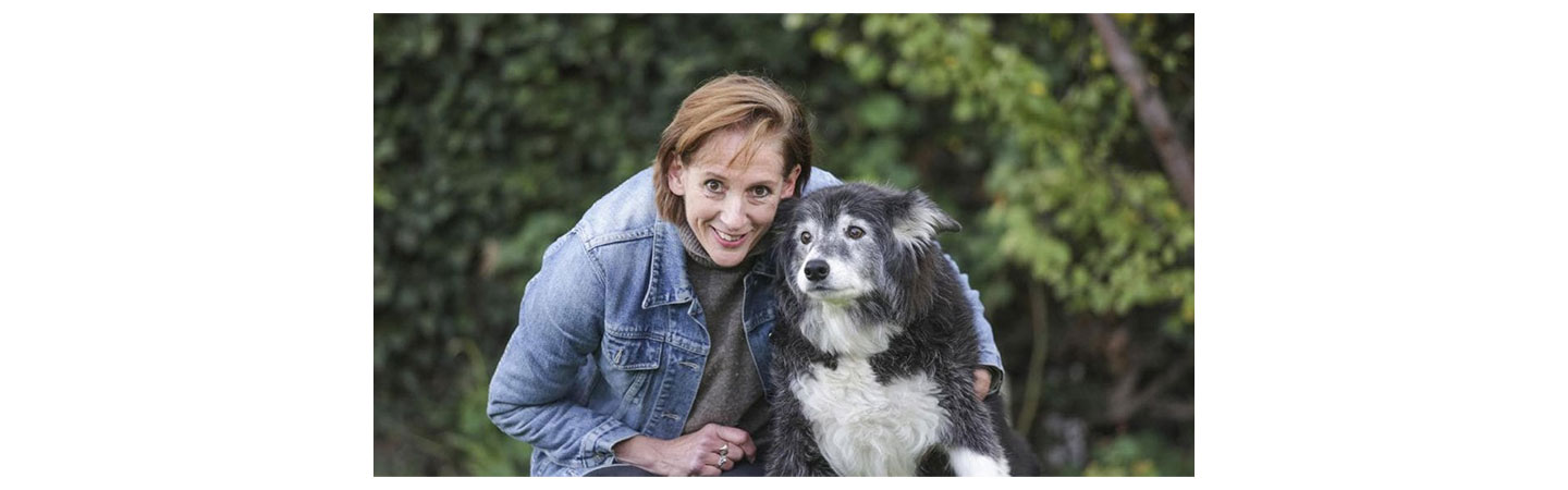 Jennifer Hunt poses with a dog that benefited from the Pet Medical Crisis Fund