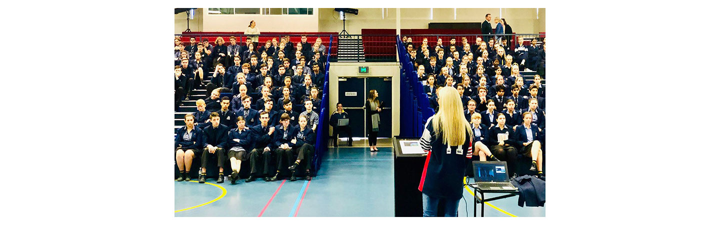 Melissa McGuinness stands in front of school children during assembly to talk to them about road safety