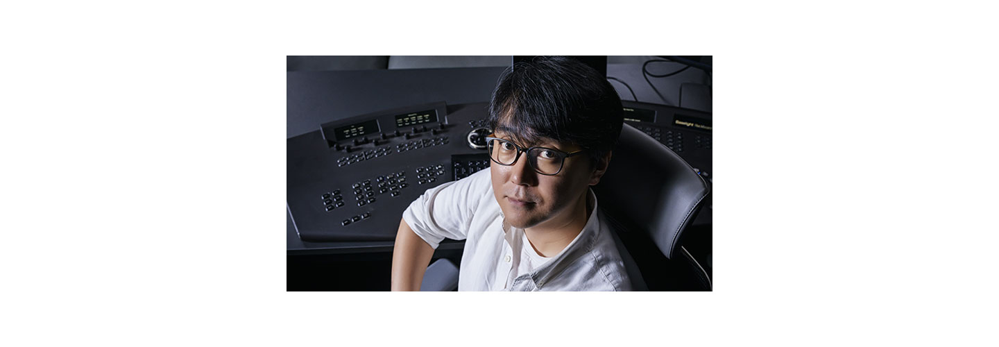 Colorist Park Jin-ho sitting in his workspace which boasts various complex and high-tech equipment