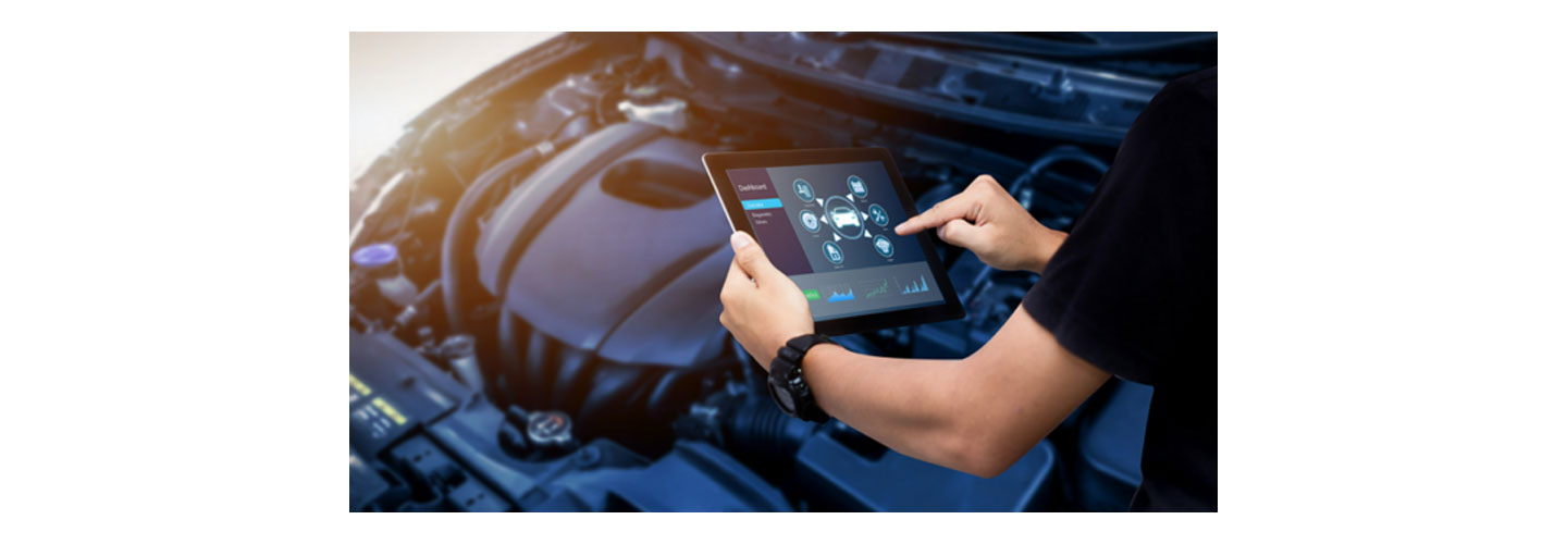 A person using a tablet PC to operate a vehicle