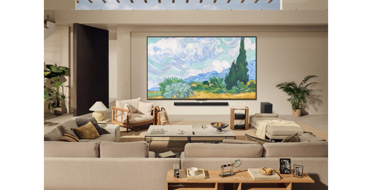 A vivid display of Van Gogh’s “Wheat Field with Cypresses” is displayed on a wall-mounted LG Smart TV through LG Gallery+ in a premium living room.