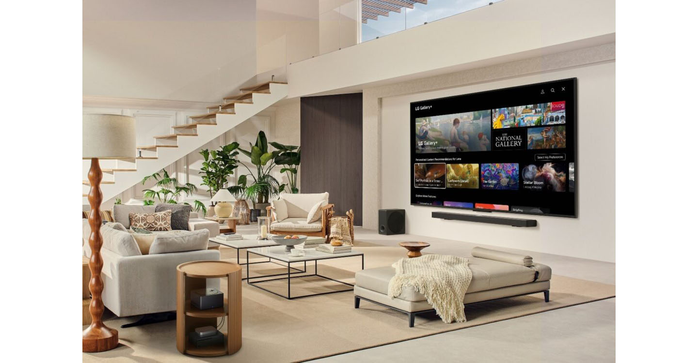 A wall-mounted LG Smart TV displays LG Gallery+ on the LG TV home interface, with a Zero Connect Box placed on a side table in a bright living room.