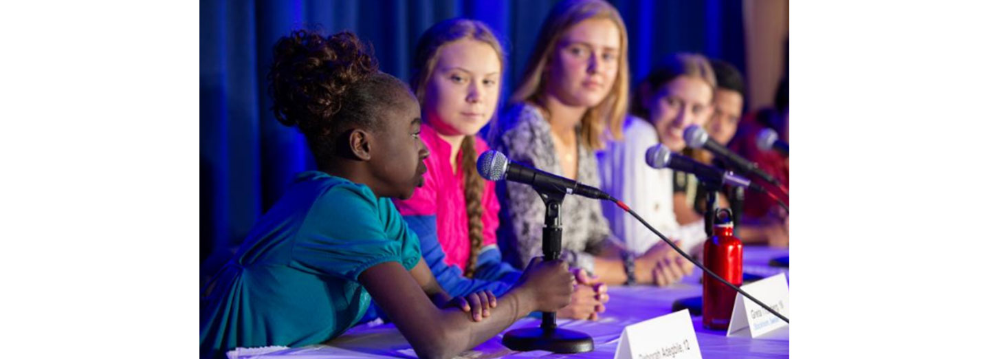  A 12-year-old girl discussing environmental issues with other inspiring young individuals, including Greta Thunberg, during a United Nations Committee event