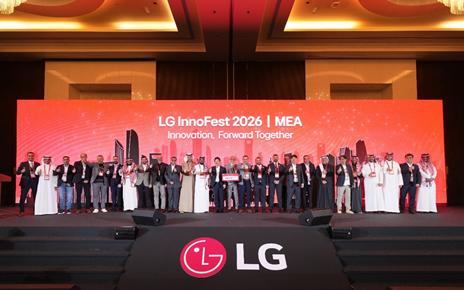 A large group of attendees give a thumbs-up on the stage of LG InnoFest 2026, with its theme "Innovation, Forward Together" behind.