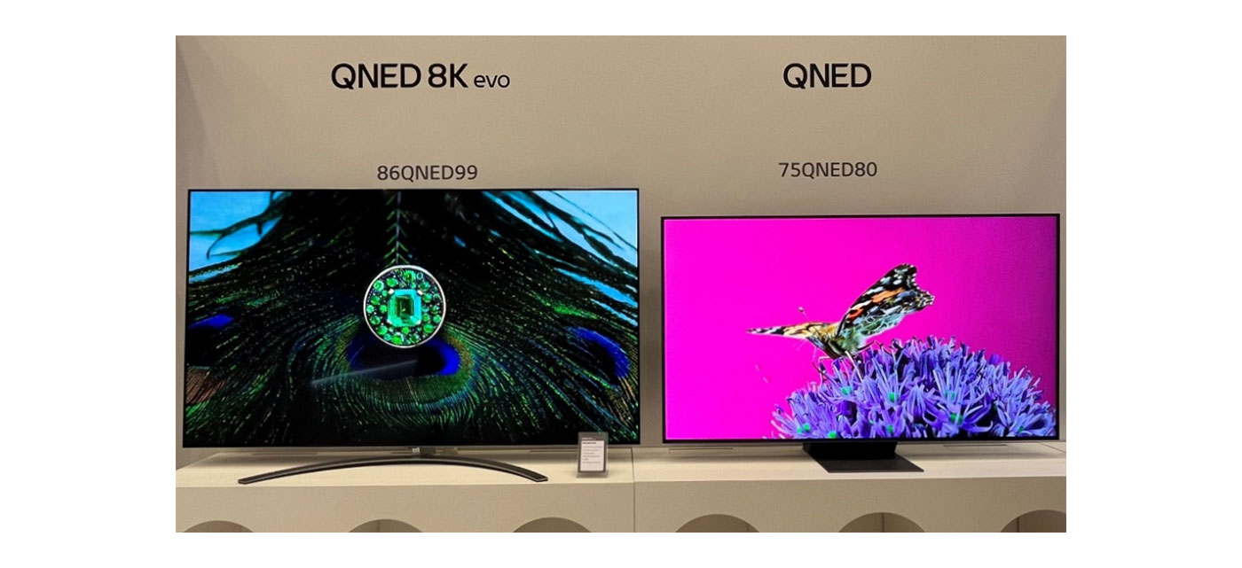 LG’s 2023 QNED 8K evo TV and QNED TV displaying the colorful images of a peacock’s tail and a butterfly at the 2023 TV showcase.
