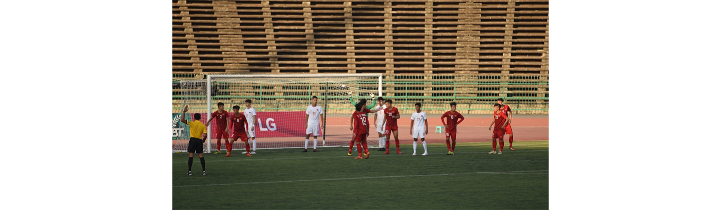 Players wait for a corner-kick inside the penalty box and there is LG’s pitch-side advertisement board behind the goal.