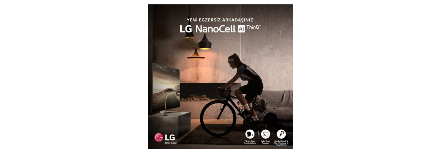 A woman participates in the LG Indoor Cycle Challenge by riding her bike in front of her living room LG NanoCell TV