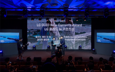 Two filmmakers receiving the LG OLED New Currents Award on the stage of the Busan International Film Festival