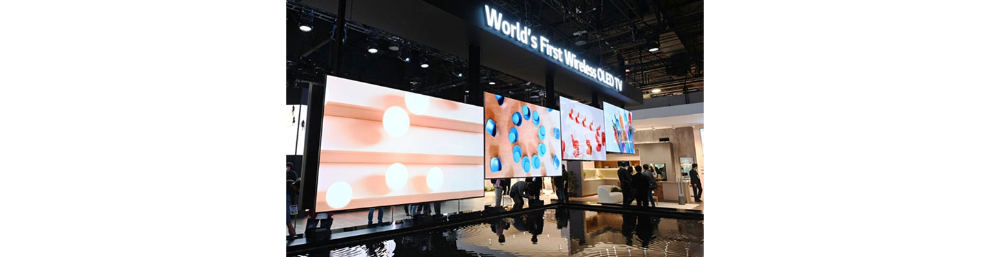 Four LG SIGNATURE OLED M models hanging under the title of World’s First Wireless OLED TV at an exhibition