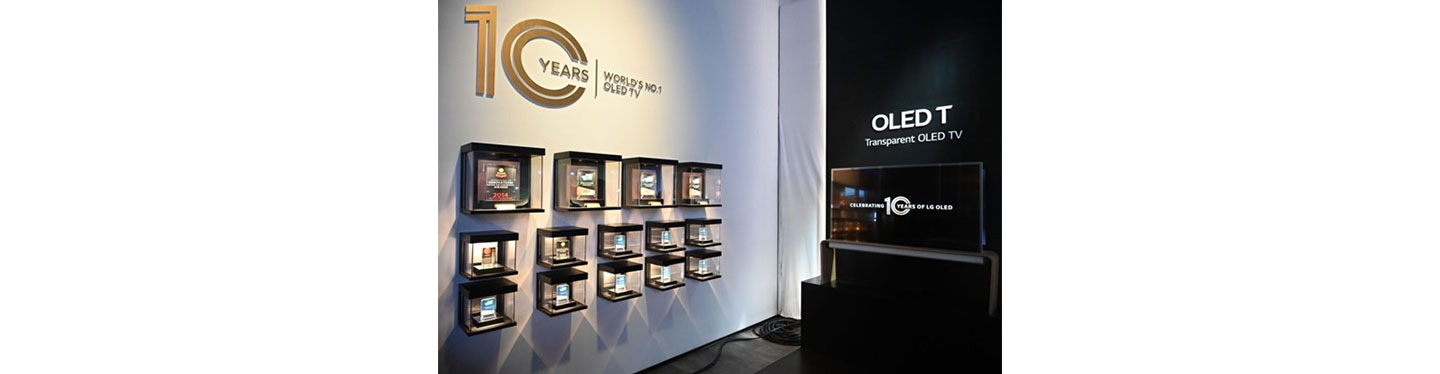 Various awards being displayed next to LG’s Transparent OLED TV at an exhibition hall commemorating LG OLED TV’s 10-year anniversary