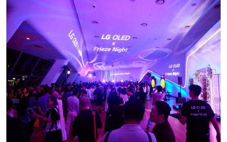 A large crowd socializing at Dongdaemun Design Plaza during LG OLED X Frieze Night