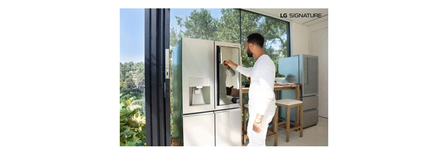 John Legend knocking on the mirrored glass panel of LG SIGNATURE InstaView Door-in-Door refrigerator
