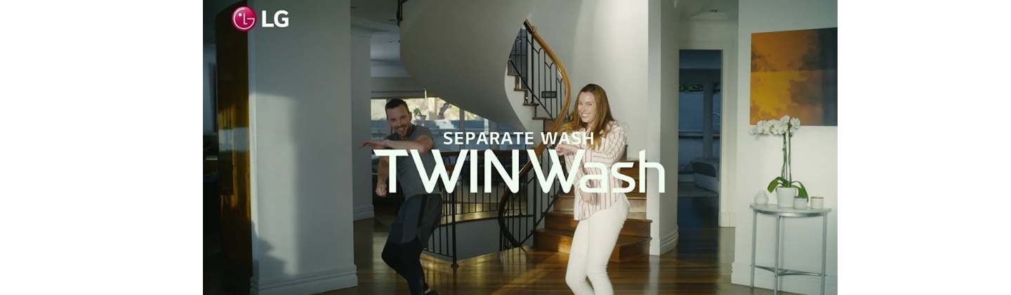 A screenshot from the LG TWINWash Dance Challenge video clip, a man and a woman dance to the music with smiles on their faces