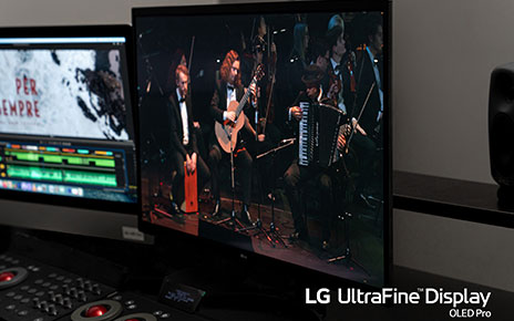 A closeup photo of LG UltraFine Display OLED Pro displaying an orchestra during its performance
