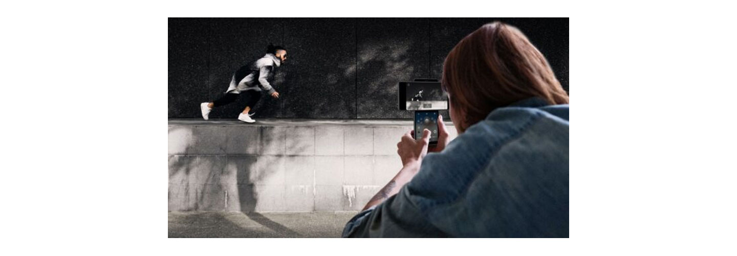 Someone taking a video of their friend doing parkour using LG Wing’s Gimbal Motion Camera to stabilize the picture