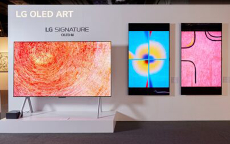 The LG SIGNATURE OLED M3 model displayed at the Hong Kong Digital Art Fair with three LG Smart TVs to its right on the wall