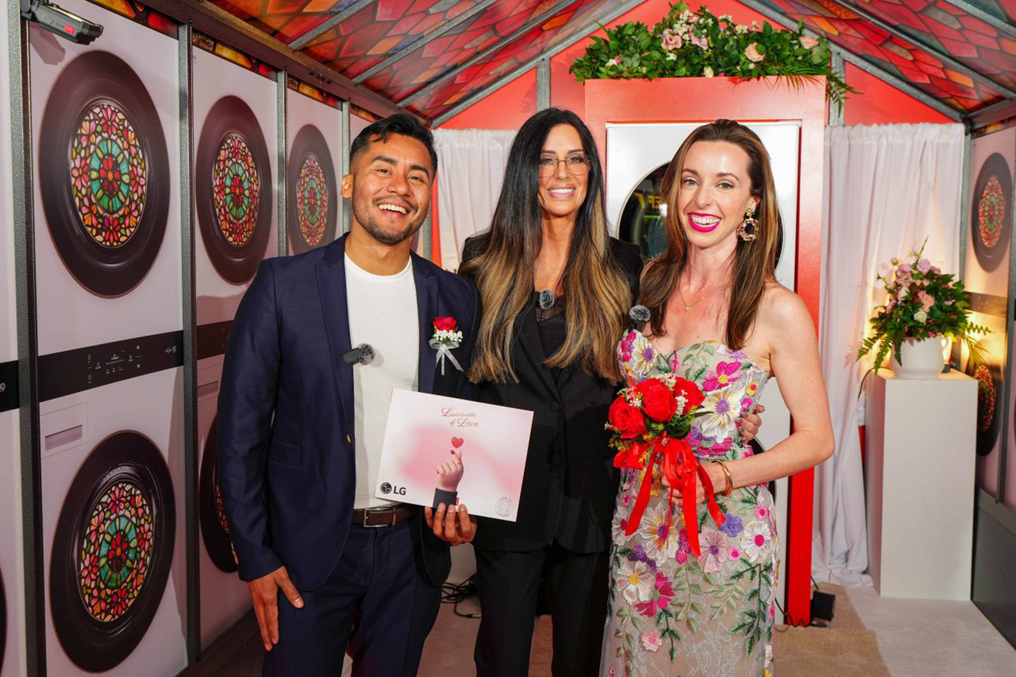 A photo of a couple with the host of a show, 'Millionaire Matchmaker'