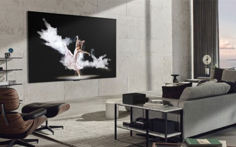 LG SIGNATURE OLED M3 TV mounted on the wall of a gray-themed living room as it displays a ballet performance
